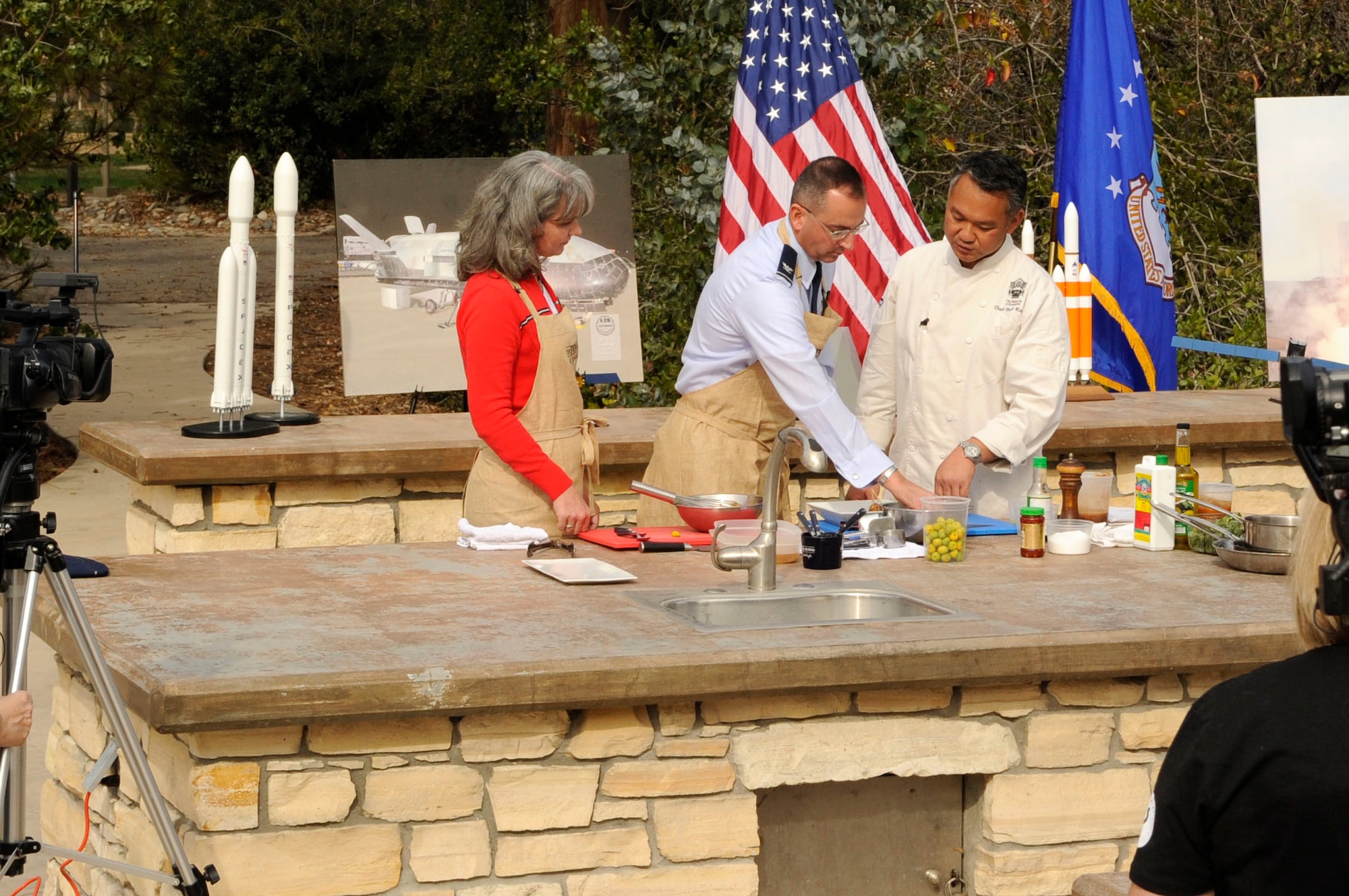 Celebrity chef Budi Kazali demonstrates how to cook a three-course meal with Col. Keith Balts, 30th Space Wing commander, and his wife Christine here Tuesday, Jan 21, 2014. The 30th SW’s mission and their cooking adventure will be highlighted on Kazali’s T.V. show, “The INN Crowd,” airing in March, 2014. (U.S. Air Force photo/Senior Airman Shane M. Phipps)