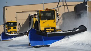 11th Civil Engineer Squadron equipment operators clear snow from the flight line at Joint Base Andrews, Md., Jan. 23, 2014. As colder temperatures surround the installation, team members remain on-call and ready to assemble within moments. Nights before forecasted flurries, personnel arrive to work hours before precipitation hits, standing ready to move as soon as the first flake falls. (U.S. Air Force photo / Airman 1st Class Nesha Humes)