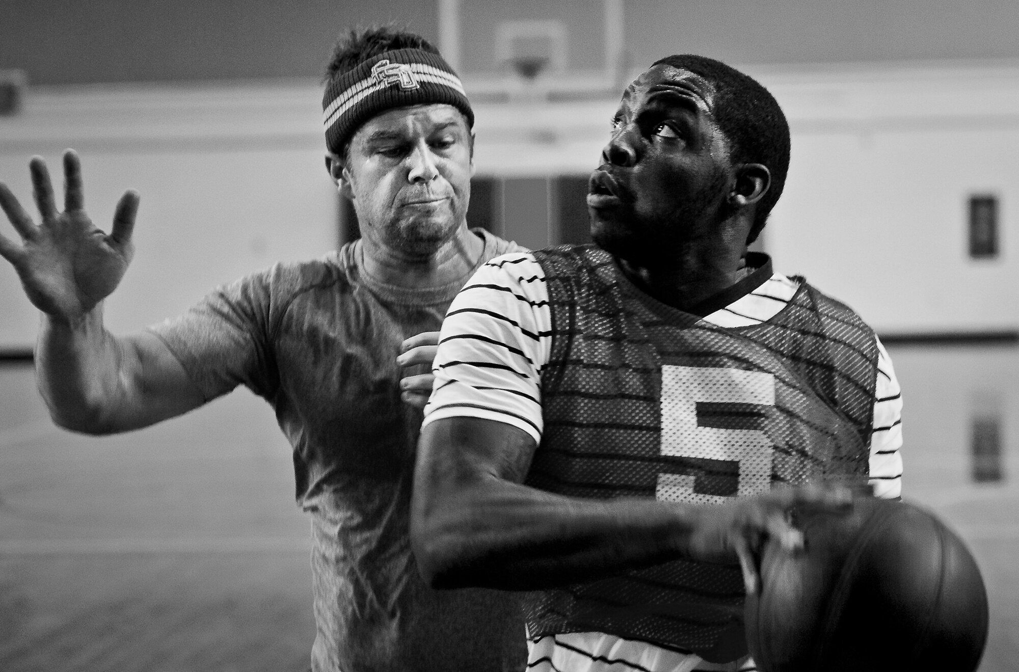 A player jumps toward the basket as a defender tries to block during a 3-on-3 basketball tournament held Jan. 24 at the Eglin Air Force Base, Fla., gym.  A total of six teams battled it out in 10-minute games in the double elimination tournament.  (U.S. Air Force photo/Samuel King Jr.)