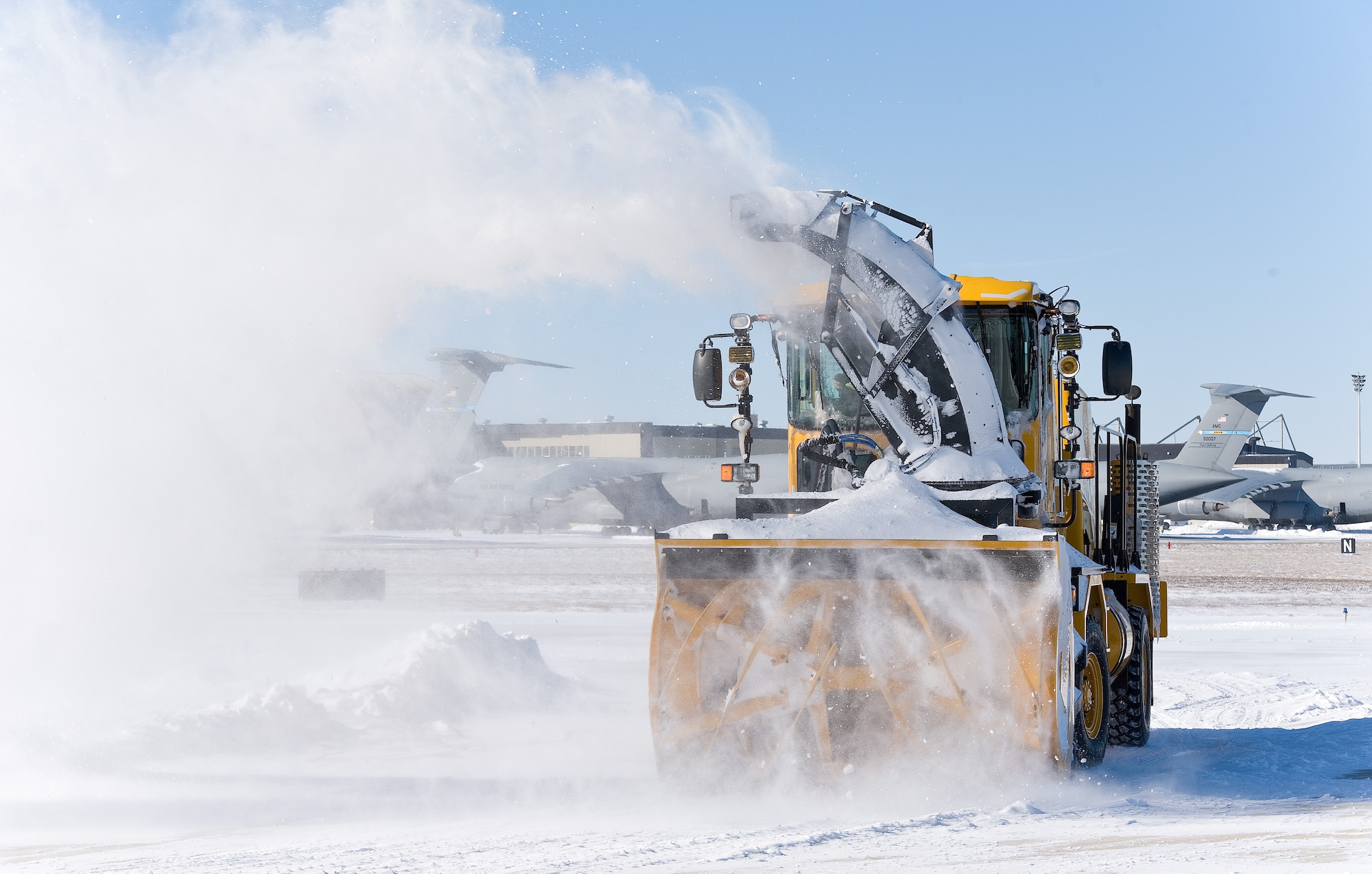 A snow blower from the 436th Civil Engineer Squadron clears snow from the runway Jan. 22, 2014, at Dover Air Force Base, Del. The base received six inches of snow from the latest snow storm to hit the base. (U.S. Air Force photo/Roland Balik)