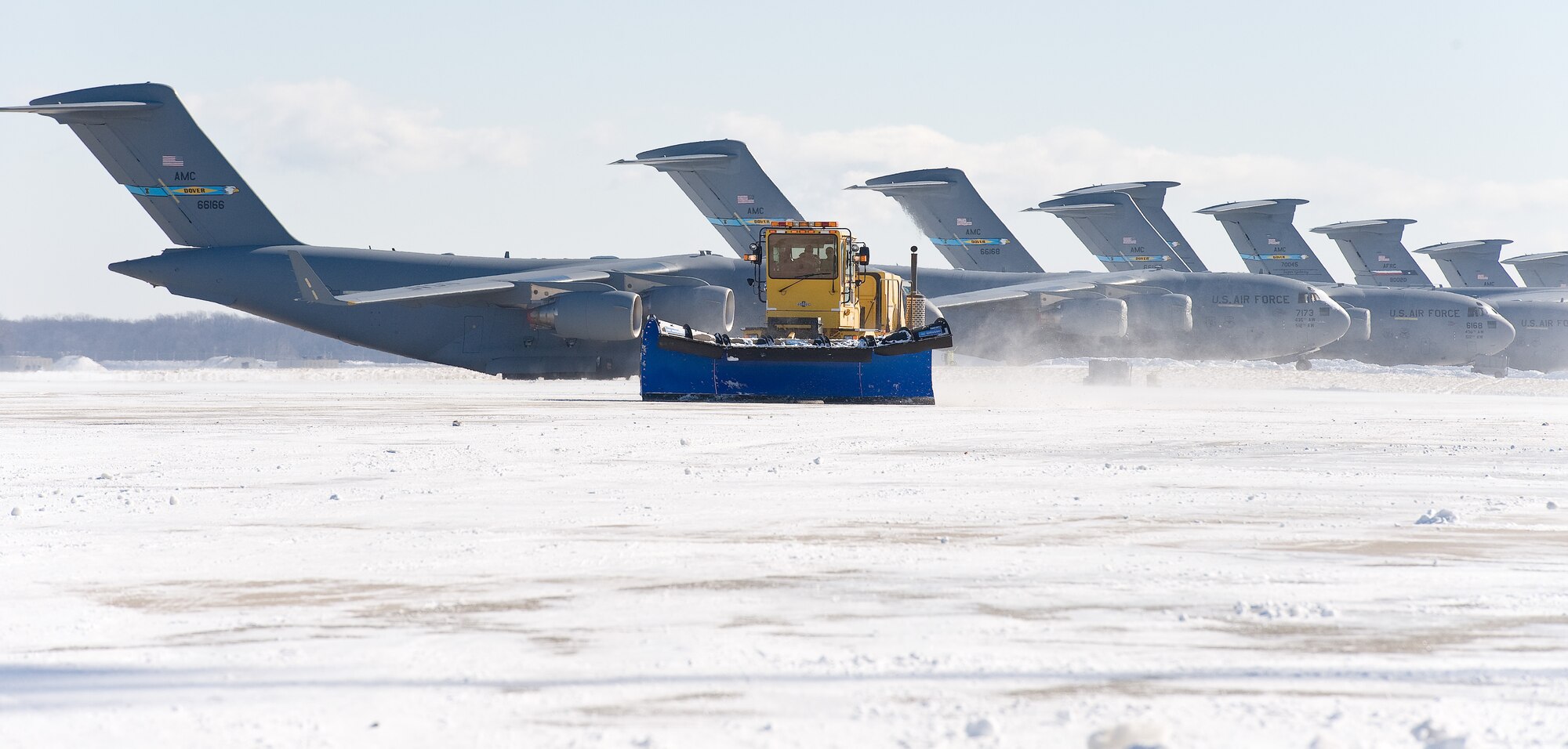 A snow plow from the 436th Civil Engineer Squadron clears snow from the flight line Jan. 22, 2014, at Dover Air Force Base, Del. As the wind-driven snow fell and even after, the base continued normal operations as Team Dover personnel initiated snow removal throughout the base. (U.S. Air Force photo/Roland Balik)