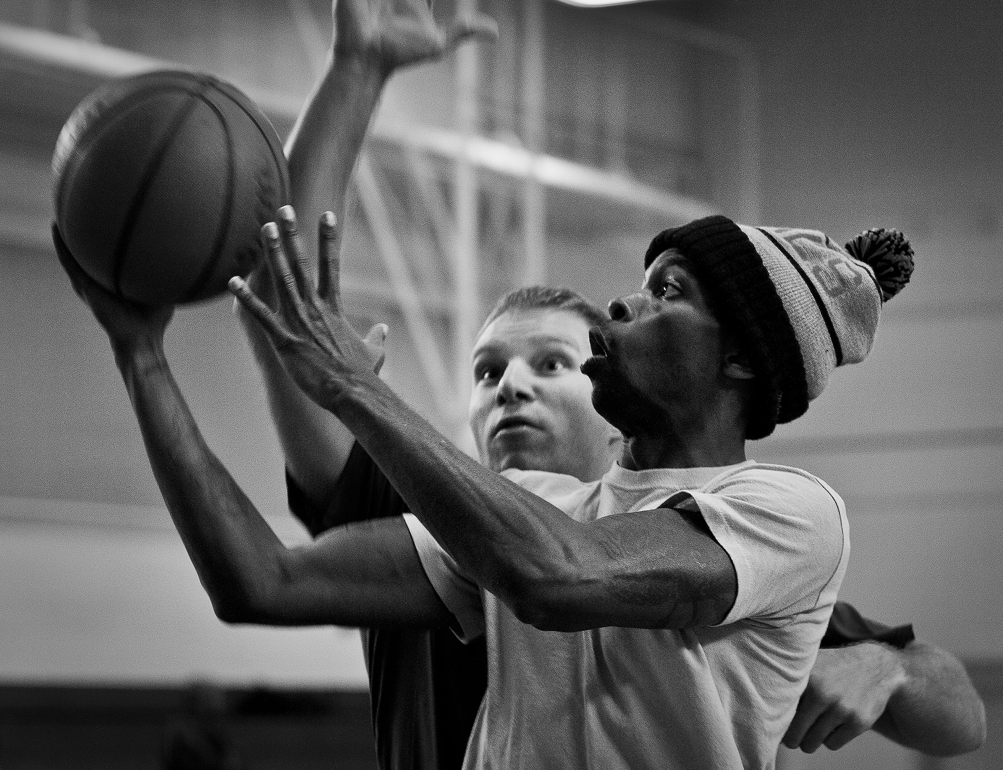 A player drives to the basket during a 3-on-3 basketball tournament held Jan. 24 at the Eglin Air Force Base, Fla., gym.  A total of six teams battled it out in 10-minute games in the double elimination tournament.  (U.S. Air Force photo/Samuel King Jr.)