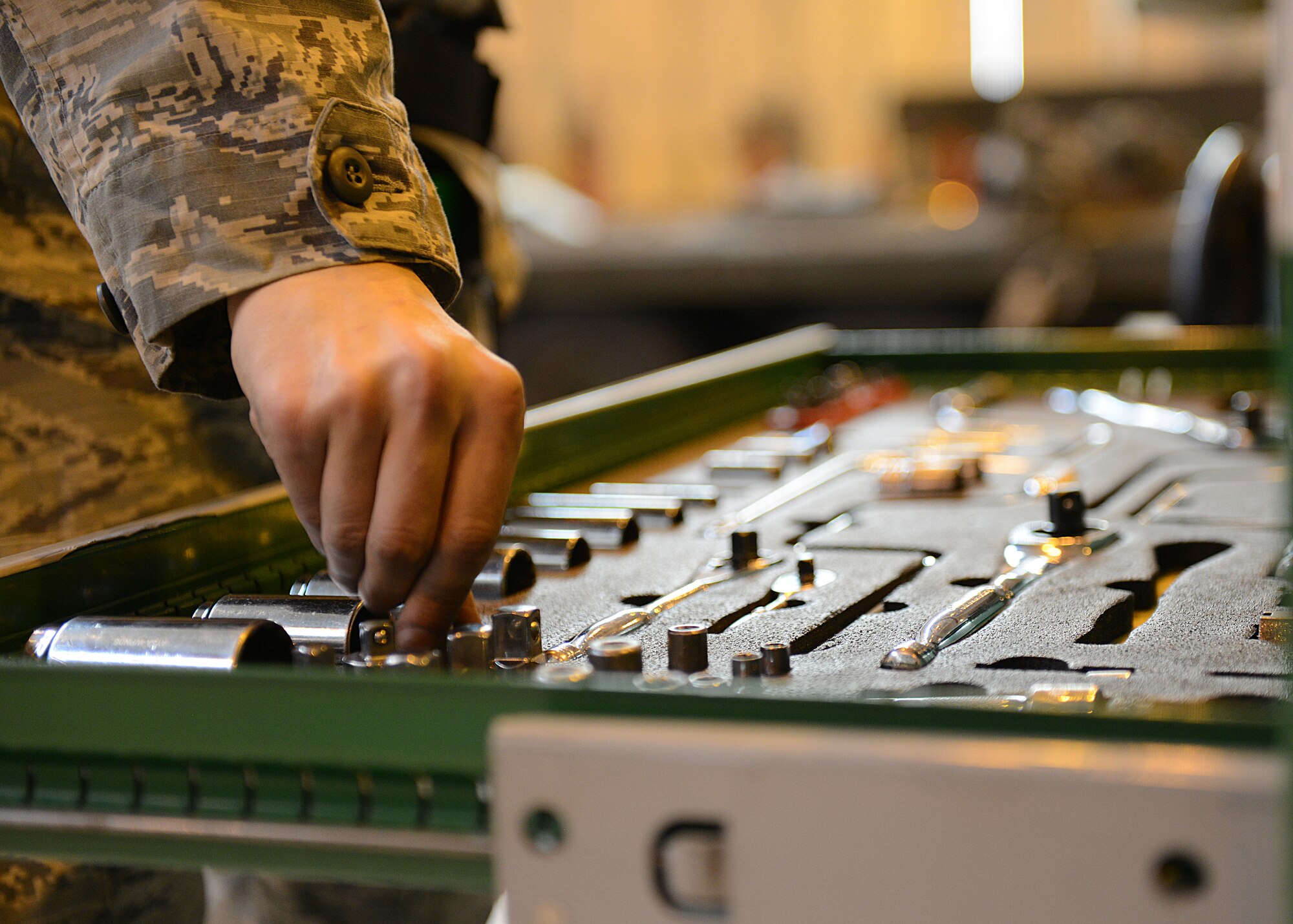 An Airman puts away tools during the annual weapons load crew competition, Jan. 23, 2014, at Aviano Air Base, Italy. During the competition, Airmen are graded on a written test, dress and appearance, their composite tool kit and the load. The winner will be announced during the Maintenance Professional of the Year Banquet. (U.S. Air Force photo/Airman 1st Class Ryan Conroy) 