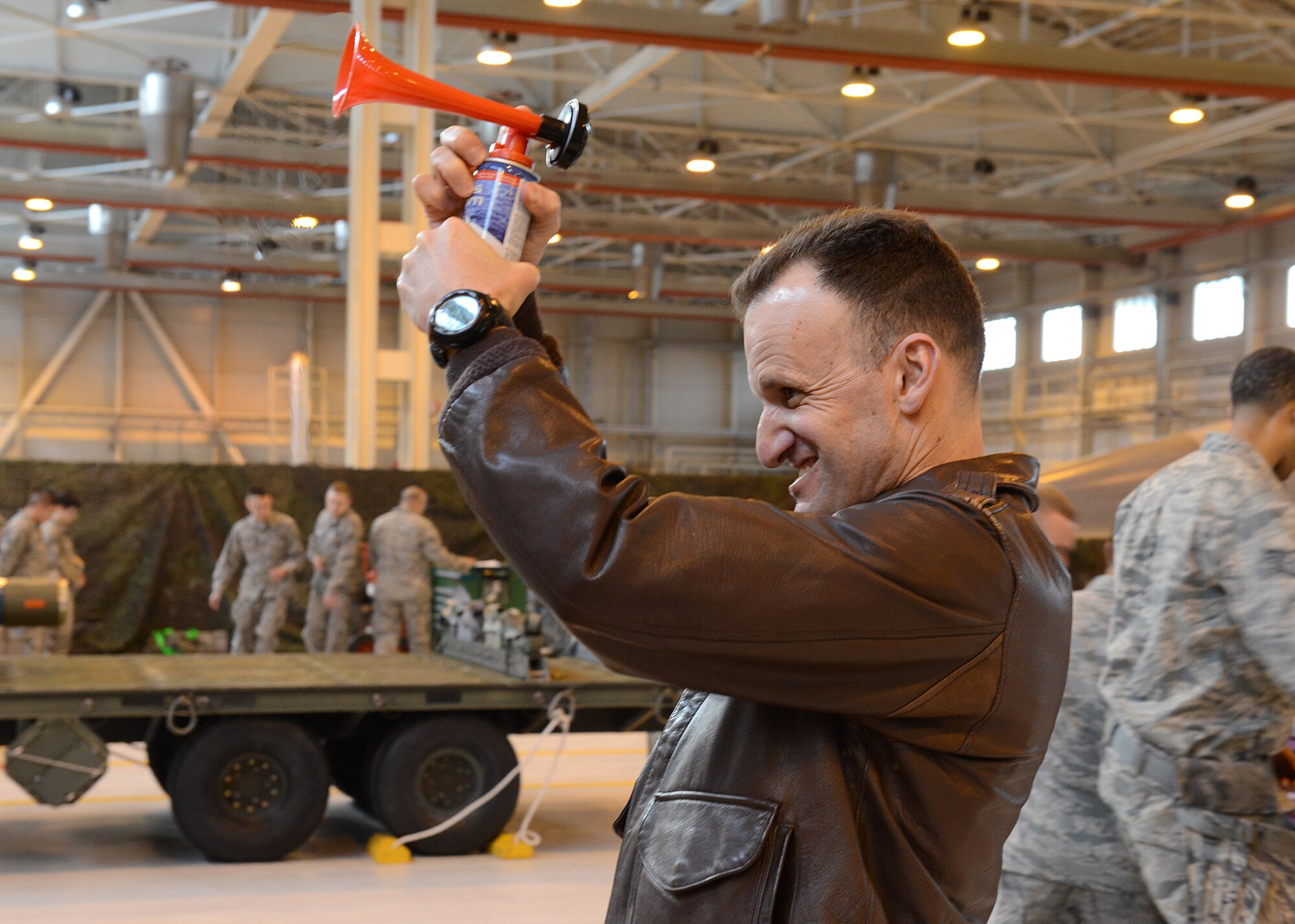Col. Anthony Abernathy, 31st Operations Group commander, sounds the air horn to mark the beginning of the annual weapons load crew competition, Jan. 23, 2014, at Aviano Air Base, Italy. The winning team will be announced during the Maintenance Professional of the Year Banquet. (U.S. Air Force photo/Airman 1st Class Ryan Conroy) 