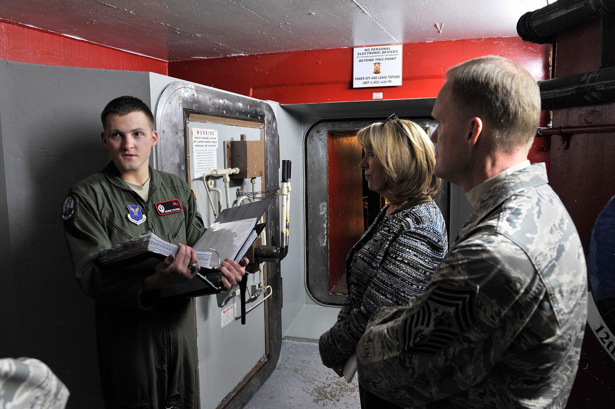 Secretary of the Air Force Deborah Lee James and Chief Master Sergeant of the Air Force James Cody receive a safety brief from deputy missile combat crew commander 2nd Lt. George Statzell, 12th Missile Squadron, before proceeding into Missile Alert Facility India-01’s underground Launch Control Capsule January 21, 2014. India-01 is located near Great Falls, Mont., and is one of 15 MAFs assigned to the 341st Missile Wing. (U.S. Air Force photo by John Turner)