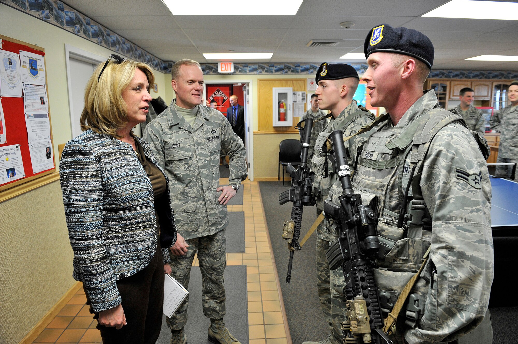 Secretary of the Air Force Deborah Lee James and Chief Master Sergeant of the Air Force James Cody receive a security forces post brief from Senior Airman Cody Mangum and Airman 1st Class Jacob Rosaia, both from the 341st Missile Security Forces Squadron, January 21, 2014, while touring Missile Alert Facility India-01 near Great Falls, Mont. (U.S. Air Force photo by John Turner)