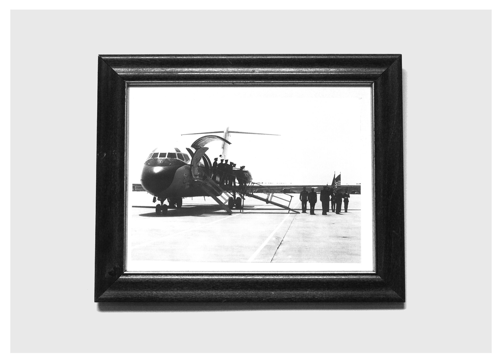 A photo of a ceremonial honor guard detail carrying an American flag draped over a casket hangs in the break room of the honor guard facility, Dec. 18 at Tyndall. The base honor guard’s primary mission is to provide military funeral honors for active duty, retiree and veteran members, who served honorably in the United States Air Force and Army Air Corp. (U.S. Air Force photo illustration by Staff Sgt. Javier Cruz)