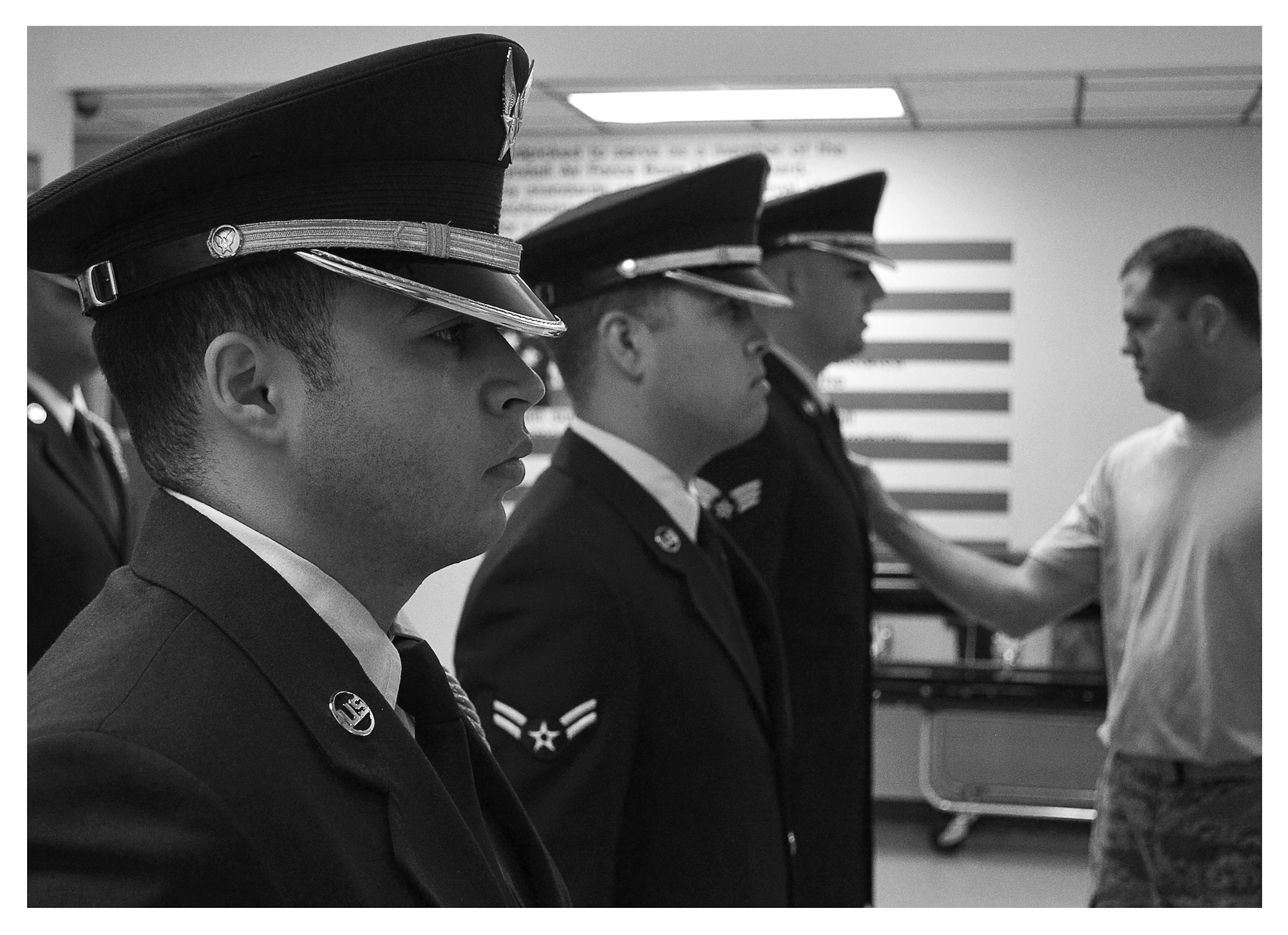 Master Sgt. Larry Cerbantec, Tyndall Base Honor Guard superintendent, inspects the uniforms of a new rotation of honor guard members, Dec .16 at Tyndall. The base honor guard’s primary mission is to provide military funeral honors for active duty, retiree and veteran members, who served honorably in the United States Air Force and Army Air Corp. (U.S. Air Force photo illustration by Staff Sgt. Javier Cruz)