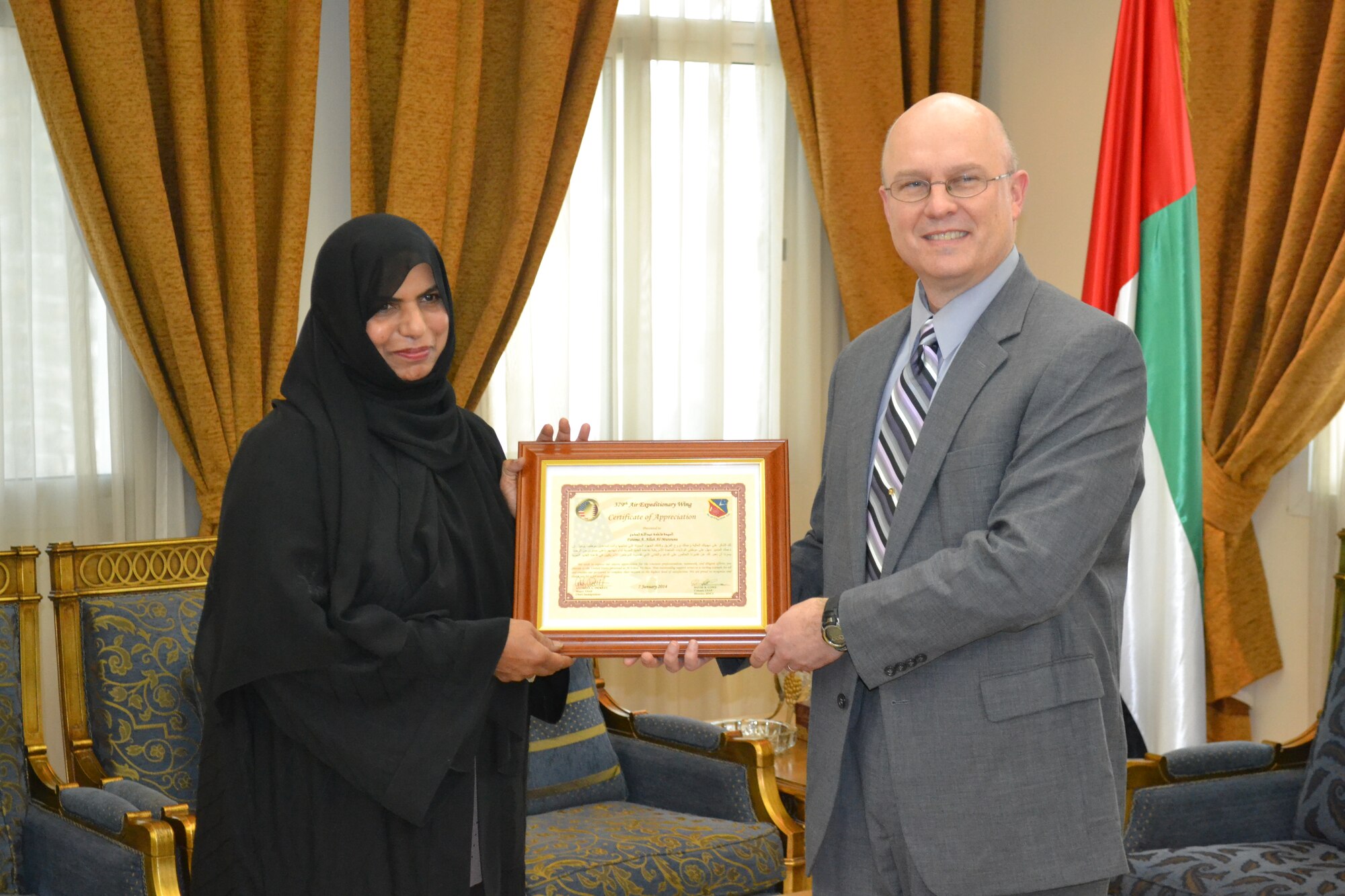 Col. David Lowe, Host Nation Coordination Cell Director at Al Udeid Air Base, Qatar, presents a certificate of appreciation to Fatema A. Allah Al-Mutawea of the United Arab Emirates consular section at the UAE Embassy in Doha, Jan. 26, 2014.  Al-Mutawea provides support above and beyond to the HNCC in processing visas for U.S. forces traveling to UAE.  Because of the strong working relationship between the 379th Air Expeditionary Wing HNCC and the UAE Embassy’s consular section, Al-Mutawea mitigated a three week backlog of UAE visa processing in the United States.  Lowe is currently stationed at Al Udeid Air Base and a native of Laurel, DE. (U.S. Air Force Photo by Maj. Nicole David)