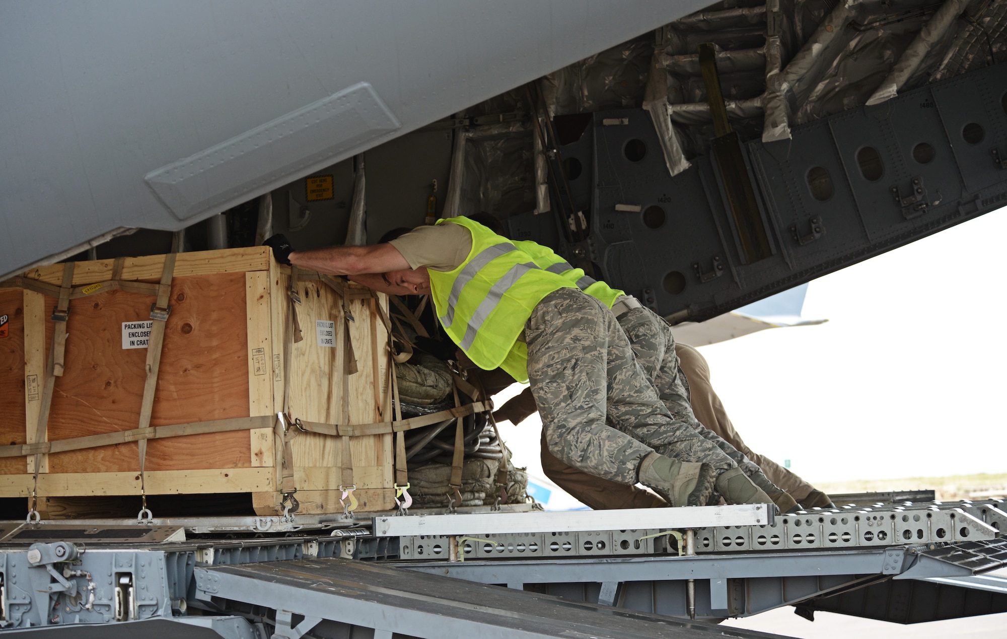 Airmen from the 435th Air Ground Operations Wing, 62nd Airlift Wing, and the 571st Contingency Response Group load vehicles, equipment and Rwandan soldiers onto a C-17 Globemaster III in Rwanda, Africa Jan. 19, 2014. U.S. forces will transport a total number of 850 Rwandan soldiers and more than 1000 tons of equipment into the Central African Republic to aid French and African Union operations against militants during this three week-long operation. (U.S. Air Force photo/ Staff Sgt. Ryan Crane)