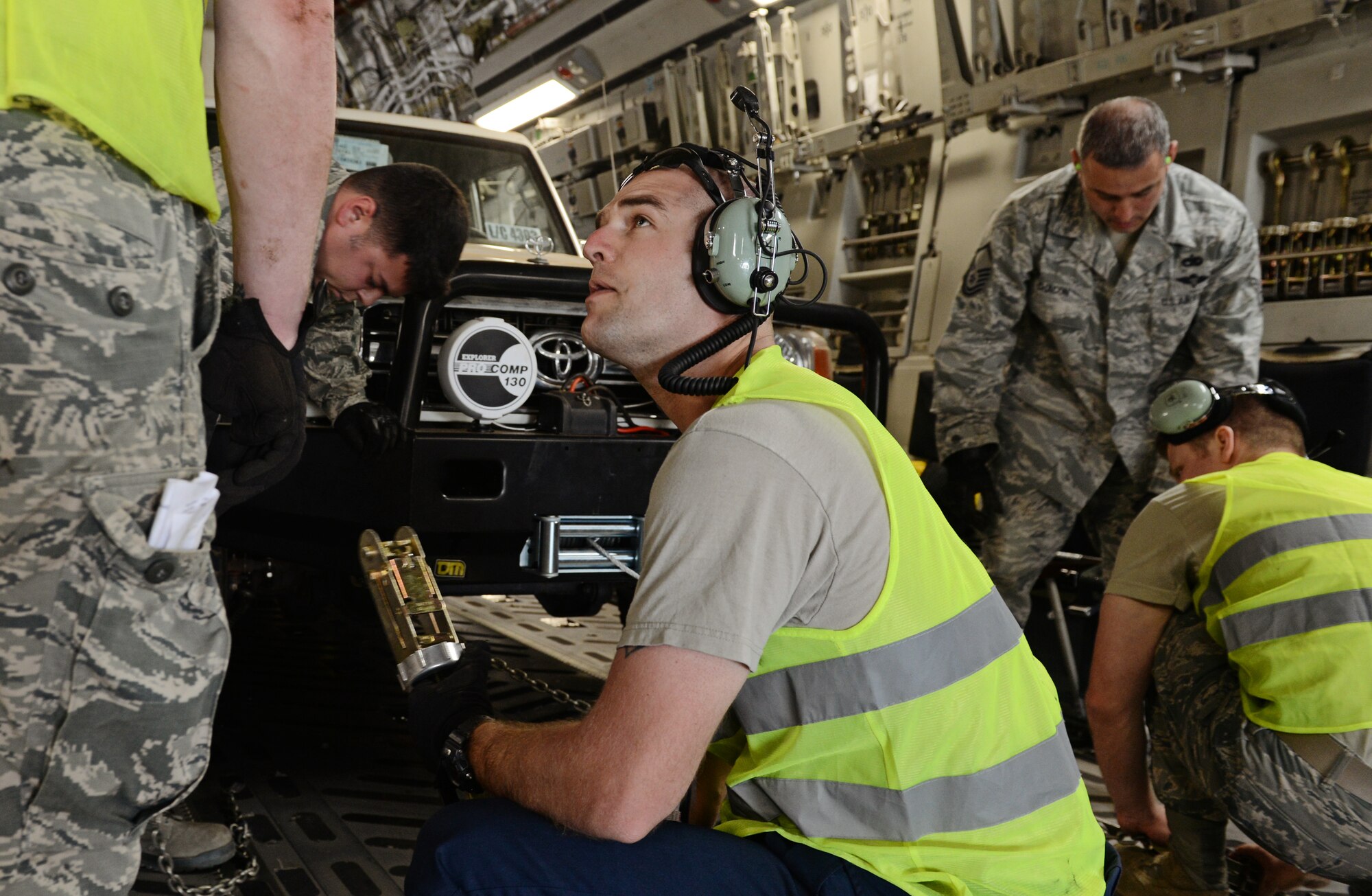 Airmen from the 435th Air Ground Operations Wing, 62nd Airlift Wing, and the 571st Contingency Response Group load vehicles, equipment and Rwandan soldiers onto a C-17 Globemaster III in Rwanda, Africa Jan. 19, 2014. U.S. forces will transport a total number of 850 Rwandan soldiers and more than 1000 tons of equipment into the Central African Republic to aid French and African Union operations against militants during this three week-long operation. (U.S. Air Force photo/ Staff Sgt. Ryan Crane)