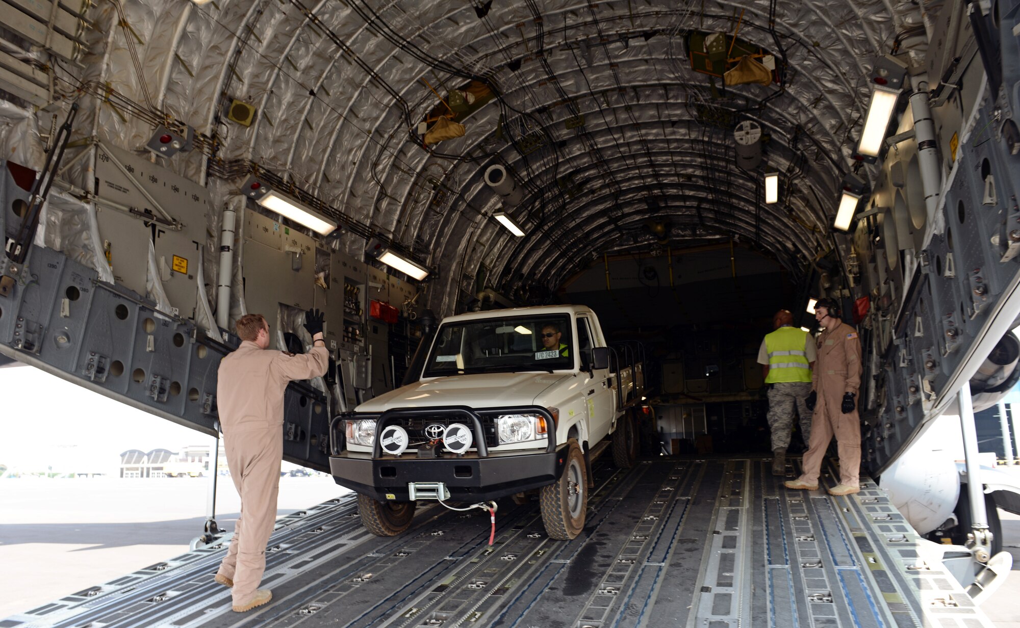 Airmen from the 435th Air Ground Operations Wing, 62nd Airlift Wing, and the 571st Contingency Response Group load vehicles, equipment and Rwandan soldiers onto a C-17 Globemaster III in Rwanda, Africa Jan. 19, 2014. U.S. forces will transport a total number of 850 Rwandan soldiers and more than 1000 tons of equipment into the Central African Republic to aid French and African Union operations against militants during this three week-long operation. (U.S. Air Force photo/ Staff Sgt. Ryan Crane)