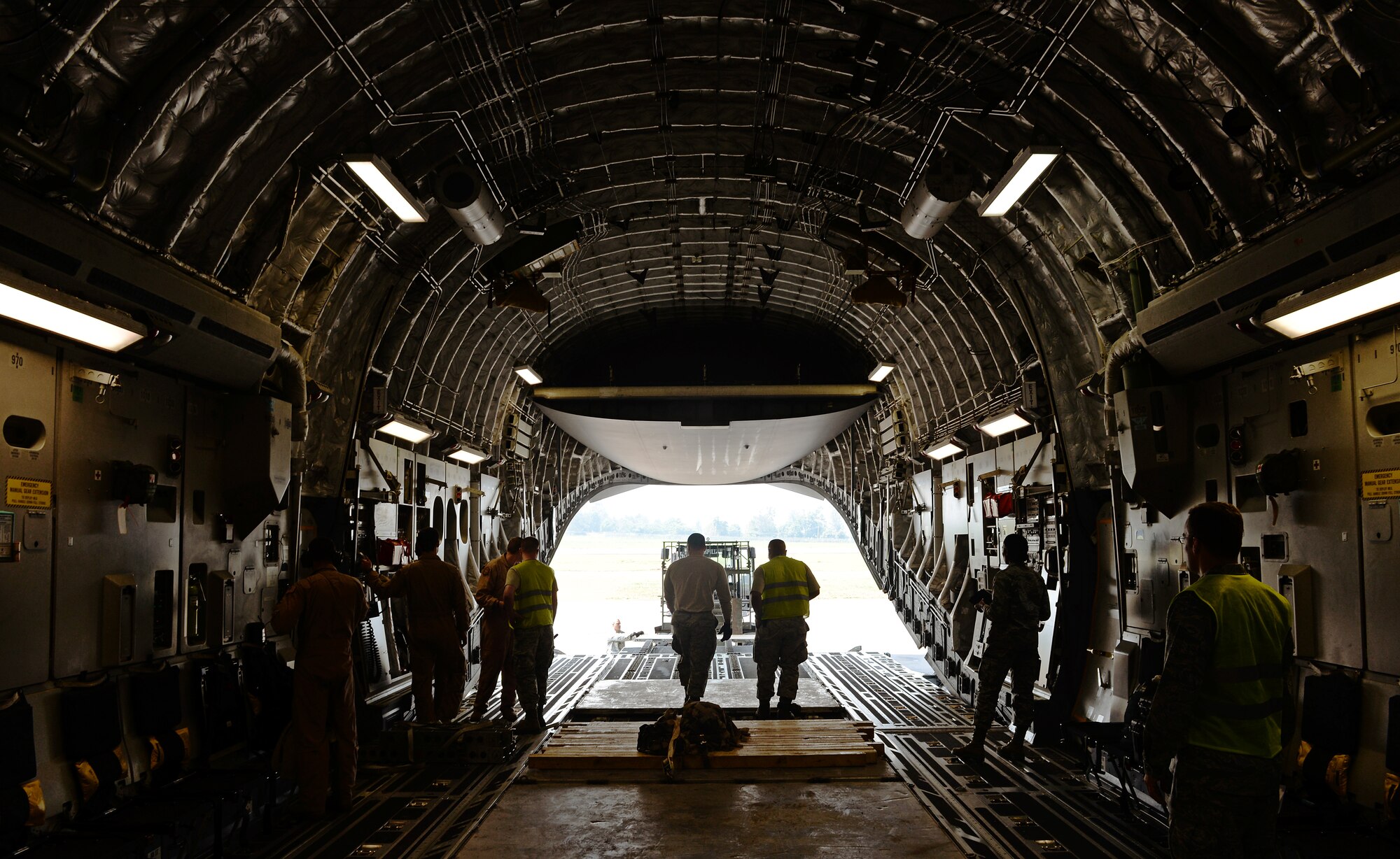 Airmen from the 435th Air Ground Operations Wing, 62nd Airlift Wing, and the 571st Contingency Response Group load vehicles, equipment and Rwandan soldiers onto a C-17 Globemaster III in Rwanda, Africa Jan. 19, 2014. U.S. forces will transport a total number of 850 Rwandan soldiers and more than 1000 tons of equipment into the Central African Republic to aid French and African Union operations against militants during this three week-long operation. (U.S. Air Force photo/ Staff Sgt. Ryan Crane)