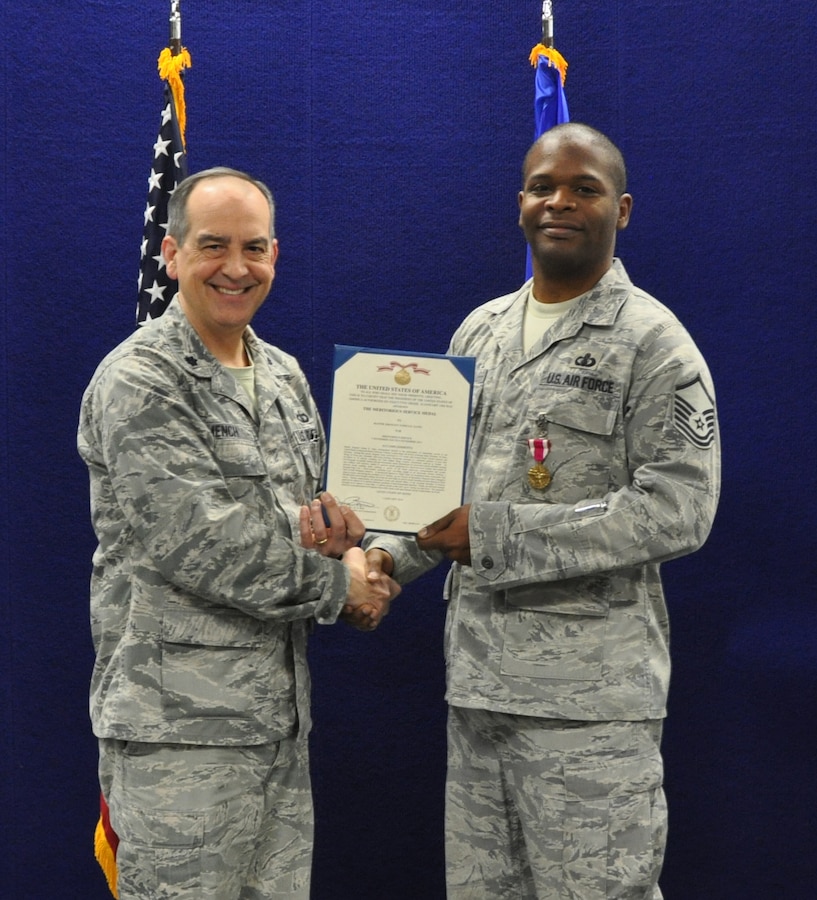 Master Sergeant Joshua Gates receives the Air Force Meritorious Service Medal.  MSgt Gates was recognized for his outstanding performance as the USAFE Band Director of Operations.
