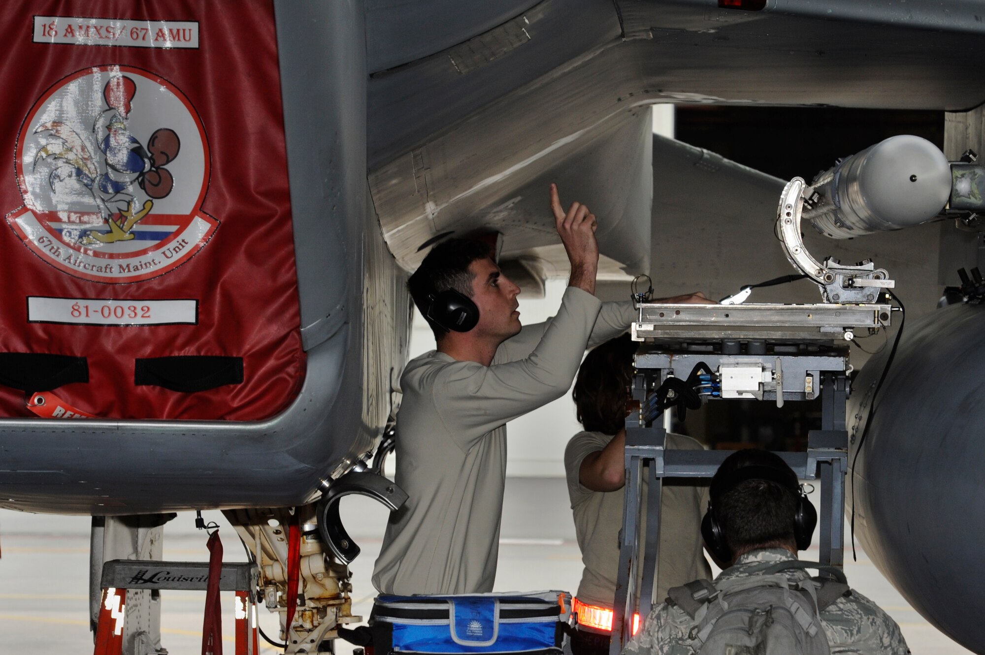 U.S. Air Force 67th Aircraft Maintenance Unit weapons load crew members remove a training missile from an F-15 Eagle during a Mission Focused Exercise on Kadena Air Base, Japan, Jan. 27, 2014. The 18th Aircraft Maintenance Squadron had 12 hours to fully generate more than 50 aircraft. (U.S. Air Force photo by Senior Airman Marcus Morris)