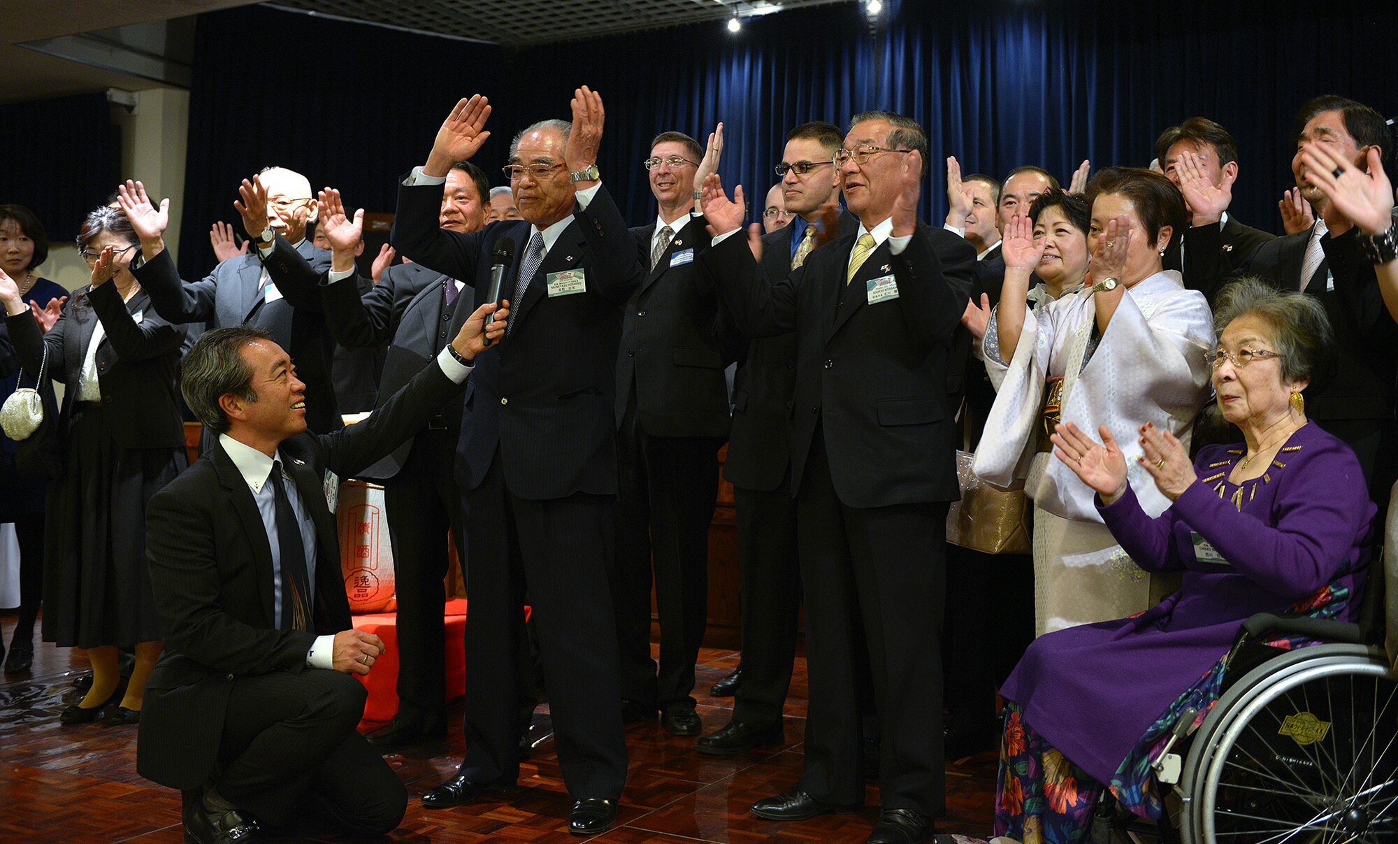 The Akashima-Yokota friendship club and its counterpart the 374th Mission Support Group perform the tejime to close the annual New Year’s party at Yokota Air Base, Japan, Jan. 25, 2014. The tejime, also called teuchi, is a Japanese custom of ceremonial hand clapping performed at the end of special events. (U.S. Air Force photo by Airman 1st Class David Danford/Released)