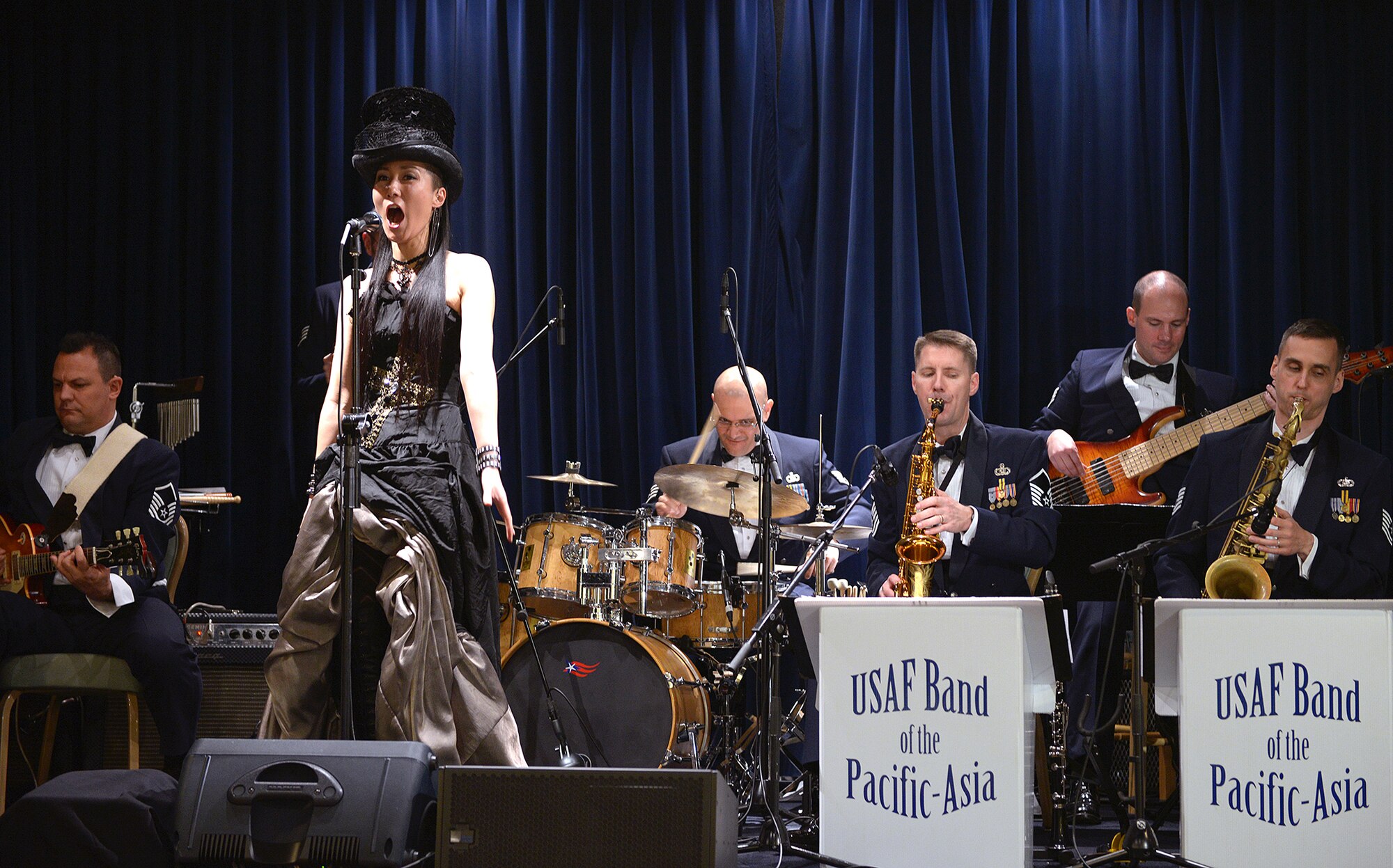 Ms. Yukako Haraguchi, a goodwill ambassador for Akishima city, sings alongside Pacific Showcase at Yokota Air Base, Japan, Jan. 25, 2014. The performance consisted of classical music from the composer Amadeus Mozart. (U.S. Air Force photo by Airman 1st Class David Danford/Released)
