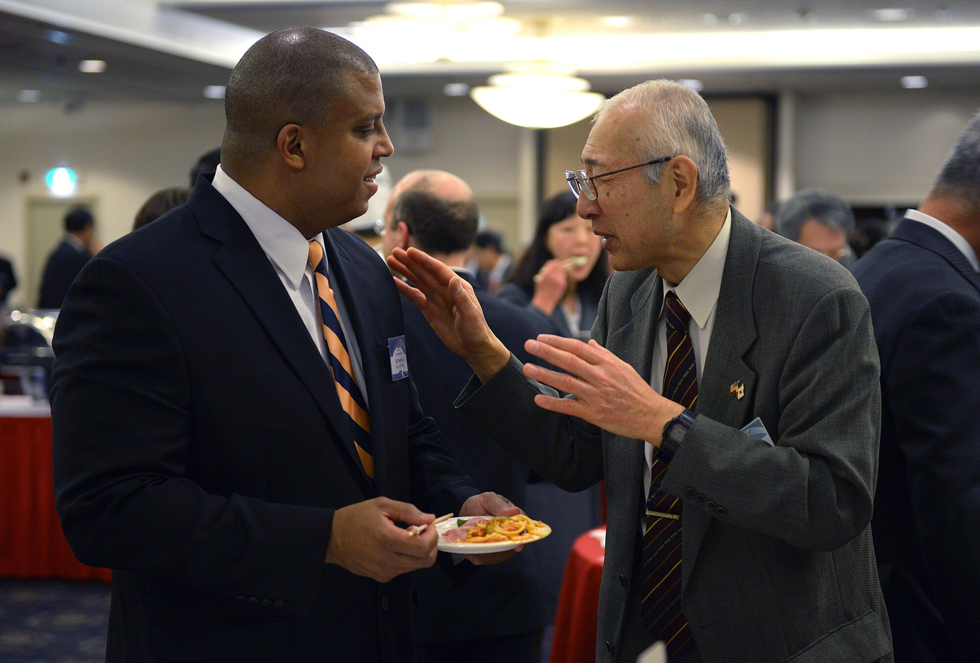 Col. Trent Tate, 374th Medical Group deputy commander, speaks with Dr. Tadashi Takagi, president of the Ome-Yokota friendship club, at Yokota Air Base, Japan, Jan. 25, 2014. Wing leadership hosts the annual New Year’s party for the Yokota friendship clubs to strengthen bonds with the community. (U.S. Air Force photo by Airman 1st Class David Danford/Released)