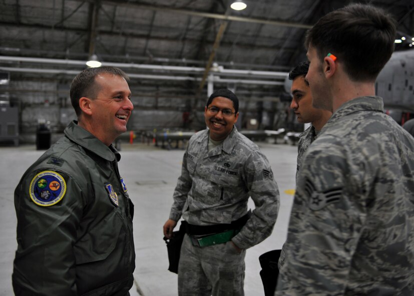 Col. James Clark, 51st Operations Group commander, congratulates members of the 25th Aircraft Maintenance Unit after they were named weapons load crew of the quarter at Osan Air Base, Republic of Korea, Jan. 24, 2014. The 25th AMU’s crew brought the coveted trophy back to their unit, avenging their loss to the 36th AMU the previous quarter. (U.S. Air Force photo/Senior Airman Siuta B. Ika)