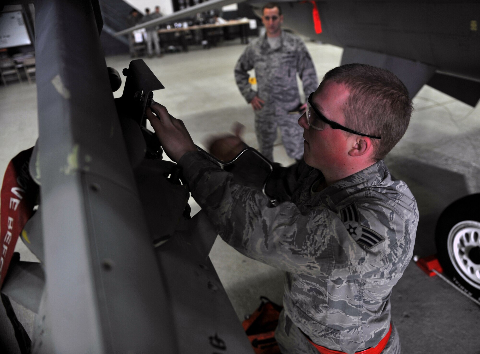 Senior Airman Caleb Burker, 36th Aircraft Maintenance Unit weapons loader, preps a panel for munitions loading during a quarterly weapons load crew competition at Osan Air Base, Republic of Korea, Jan. 24, 2014. Load crew competitions are held to give weapons personnel the opportunity to display their war-fighting skills and to unveil the best weapons load crew for a particular quarter during the year. (U.S. Air Force photo/Senior Airman Siuta B. Ika)