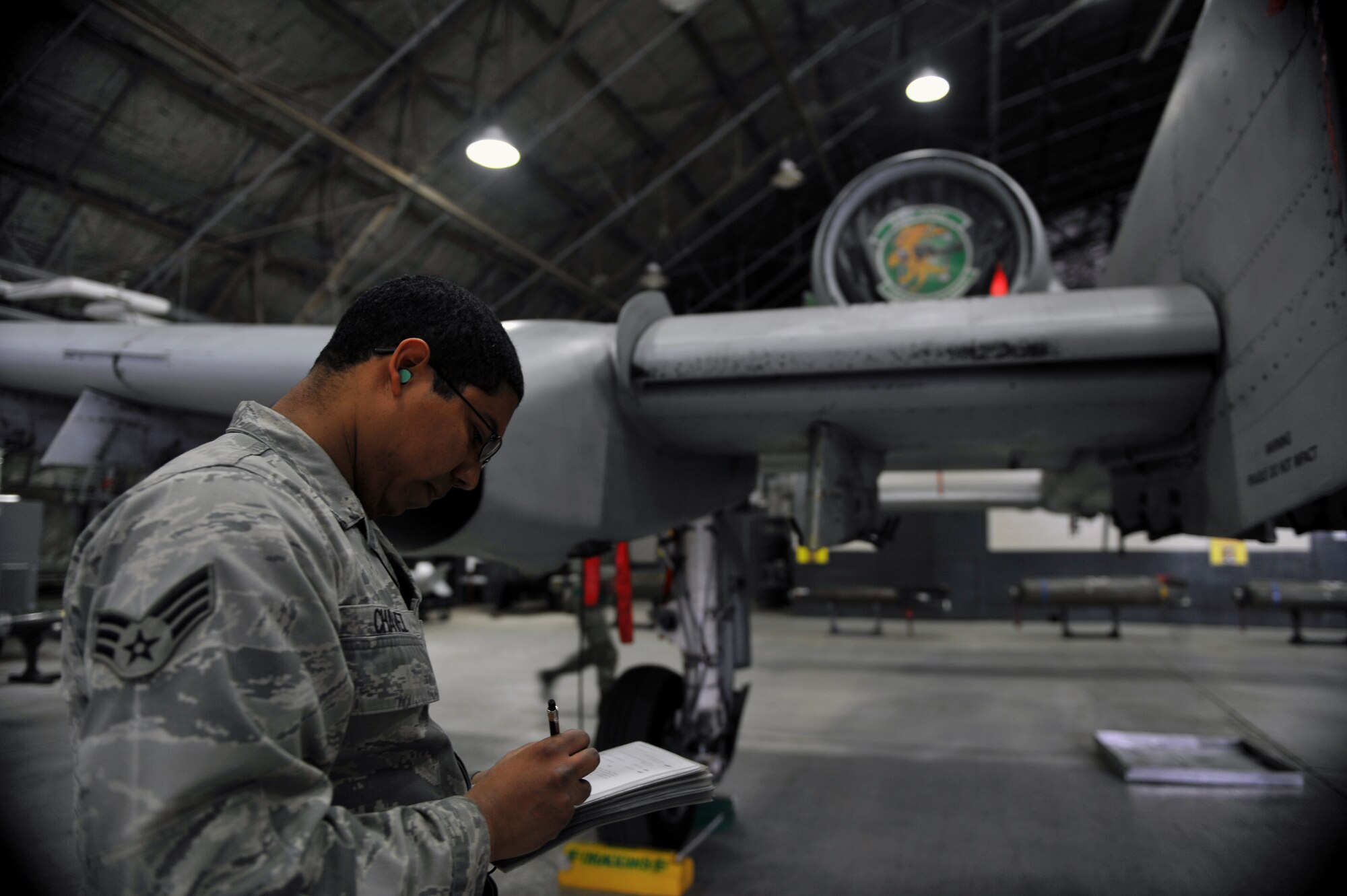 Senior Airman Antonio Chavez, 25th Aircraft Maintenance Unit weapons loader, fills out a checklist during a quarterly weapons load crew competition at Osan Air Base, Republic of Korea, Jan. 24, 2014. In addition to the weapons loading, crews are also inspected on their dress and appearance, and have their tool boxes inspected for good order to determine the 51st Maintenance Group’s best weapons load crew of the quarter. (U.S. Air Force photo/Senior Airman Siuta B. Ika)