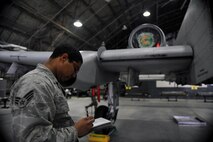 Senior Airman Antonio Chavez, 25th Aircraft Maintenance Unit weapons loader, fills out a checklist during a quarterly weapons load crew competition at Osan Air Base, Republic of Korea, Jan. 24, 2014. In addition to the weapons loading, crews are also inspected on their dress and appearance, and have their tool boxes inspected for good order to determine the 51st Maintenance Group’s best weapons load crew of the quarter. (U.S. Air Force photo/Senior Airman Siuta B. Ika)