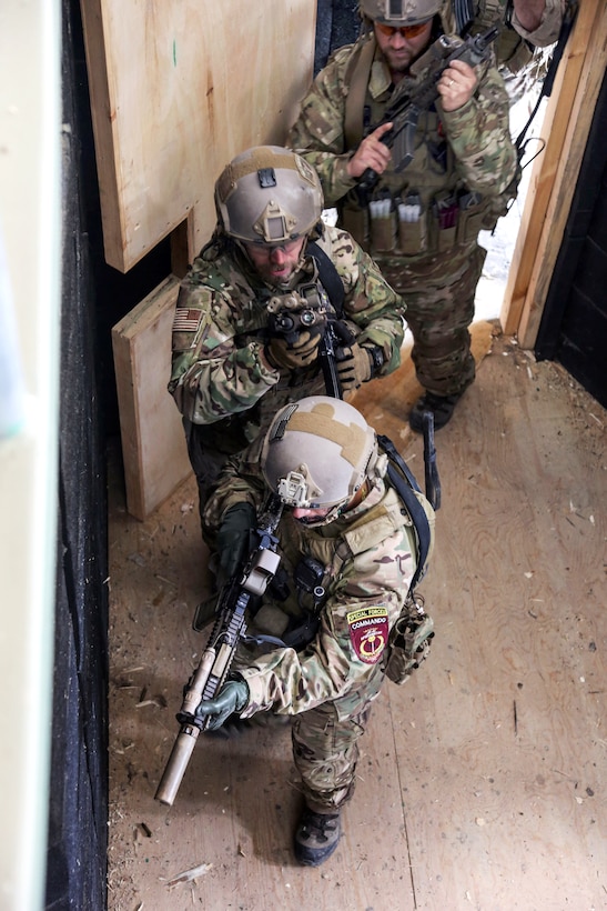 U.S. Special Forces soldiers prepare to enter and clear a room while conducting a close-quarters battle drill at a shoot house near Camp Commando in Kabul province, Afghanistan, Jan. 23, 2014.