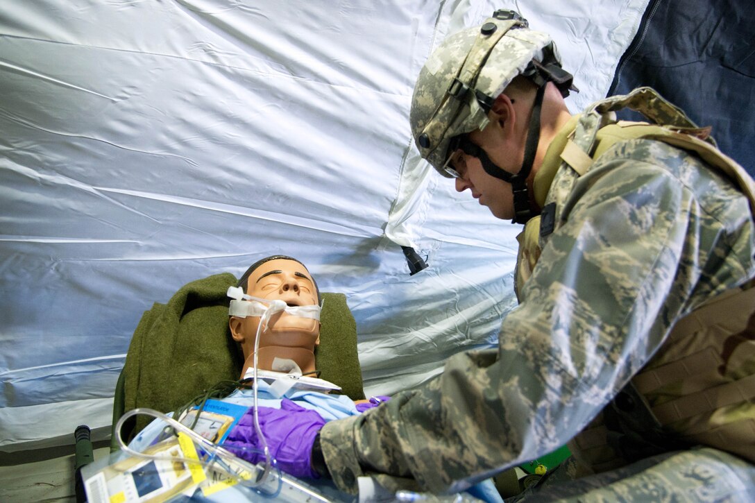 U.s. Air Force Lt. Col. Alan Guhlke Checks The Vital Signs Of A 