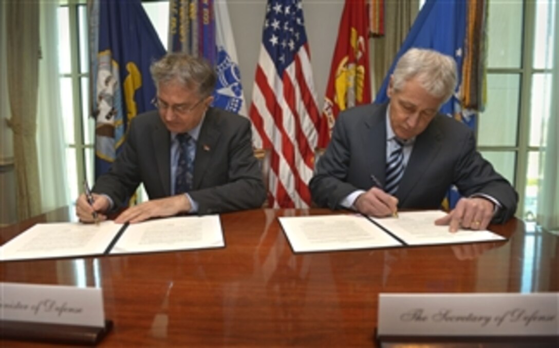 U.S. Defense Secretary Chuck Hagel, right, and Serbian Defense Minister Nebojsa Rodic sign an agreement on the general security of military information as they meet at the Pentagon, Jan. 27, 2014. The agreement ensures protection of military information and enables further military-to-military cooperation. 