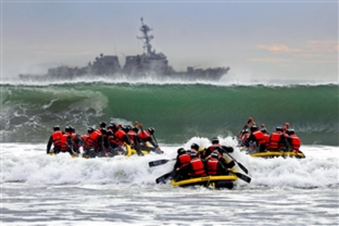 Students participate in the Navy Basic Underwater Demolition course during an evolution known as "surf passage" on Amphibious Base Coronado, Calif., Jan. 21, 2014. The evolution is part of training to be a SEAL, which is the maritime component of U.S. Special Forces. SEALs are trained to conduct a variety of operations from the sea, air and land.