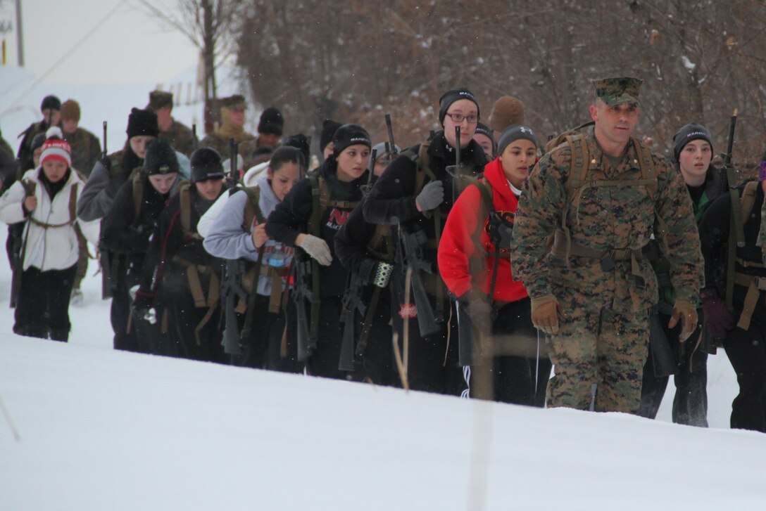 Female poolees hike through the trails around Historic Fort Snelling with the Marines of Marine Corps Recruit Station Twin Cities, Jan. 26. During the hike, the poolees carried rubber rifles and a heavily loaded pack to simulate the burdens they will be expected to carry in Marine recruit training. 