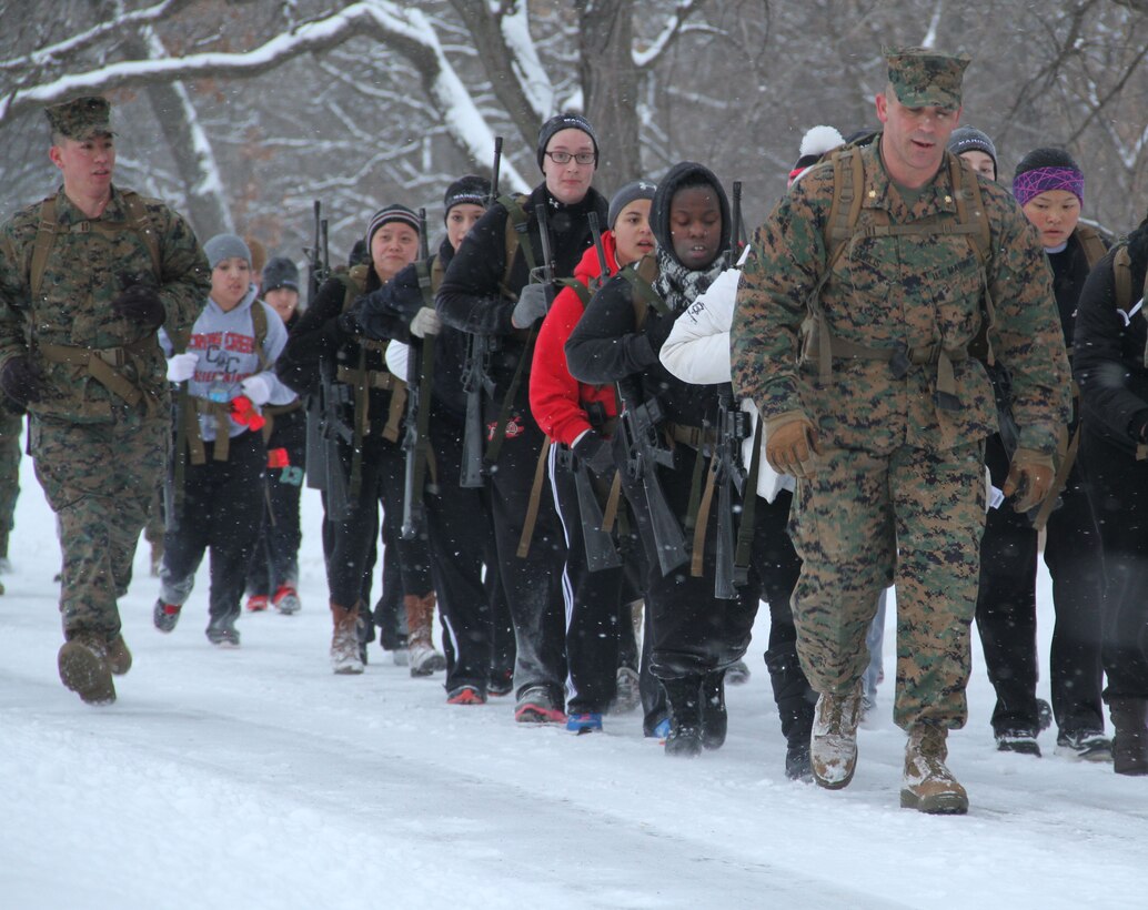 Female poolees hike through the trails around Historic Fort Snelling with the Marines of Marine Corps Recruit Station Twin Cities, Jan. 26. During the hike, the poolees carried rubber rifles and a heavily loaded pack to simulate the burdens they will be expected to carry in Marine recruit training.