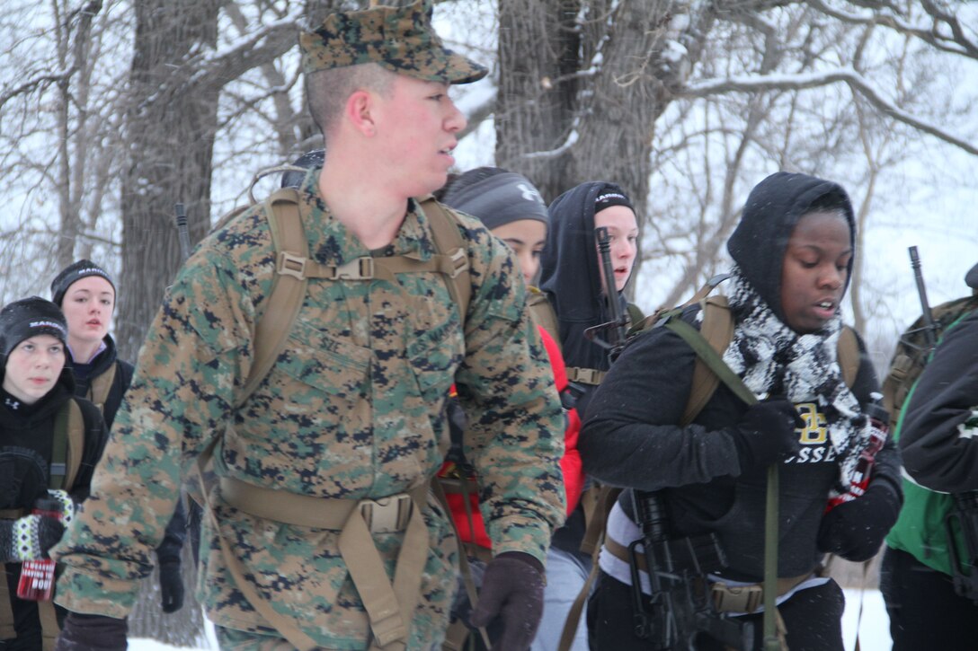 Female poolees hike through the trails around Historic Fort Snelling with the Marines of Marine Corps Recruit Station Twin Cities, Jan. 26. During the hike, the poolees carried rubber rifles and a heavily loaded pack to simulate the burdens they will be expected to carry in Marine recruit training.