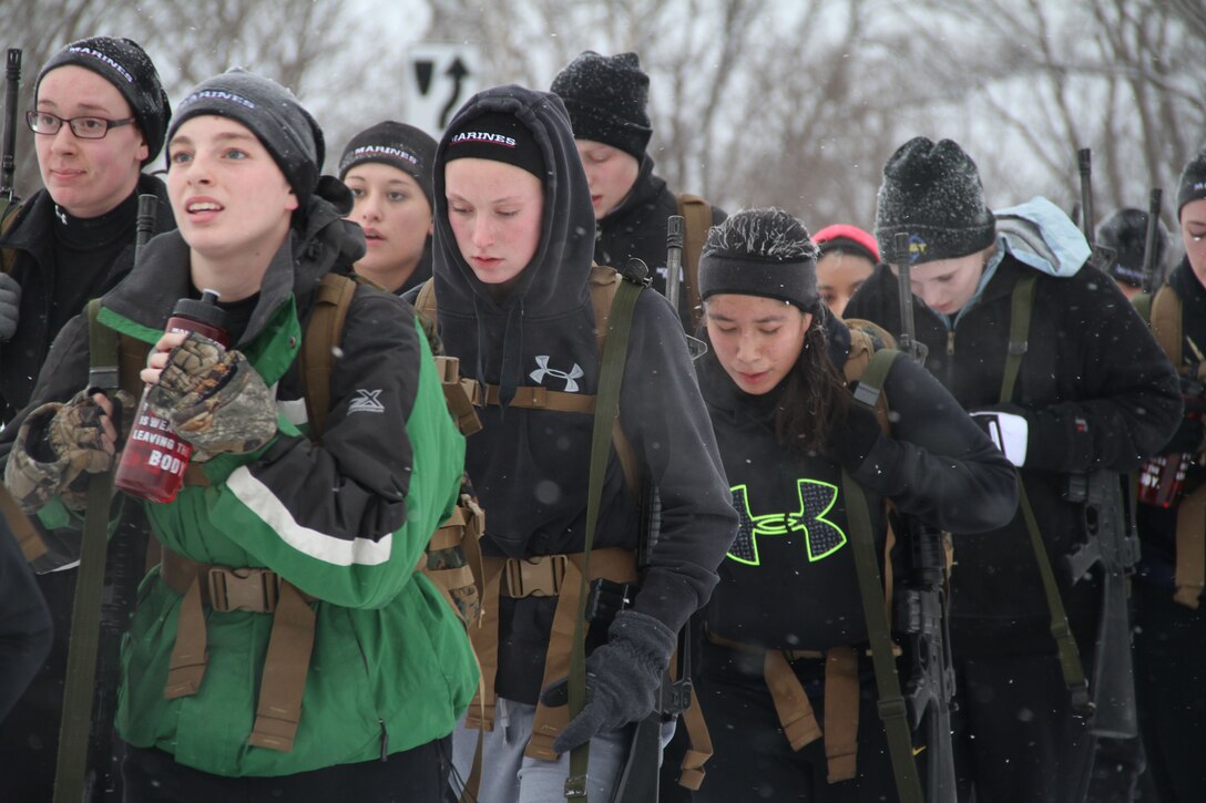 Female poolees hike through the trails around Historic Fort Snelling with the Marines of Marine Corps Recruit Station Twin Cities, Jan. 26. During the hike, the poolees carried rubber rifles and a heavily loaded pack to simulate the burdens they will be expected to carry in Marine recruit training.