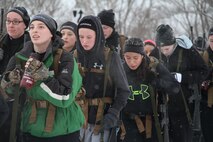 Female poolees hike through the trails around Historic Fort Snelling with the Marines of Marine Corps Recruit Station Twin Cities, Jan. 26. During the hike, the poolees carried rubber rifles and a heavily loaded pack to simulate the burdens they will be expected to carry in Marine recruit training.
