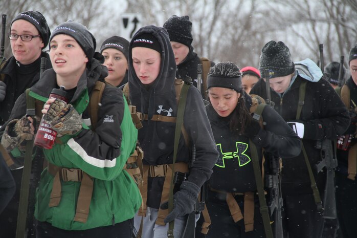 Female poolees hike through the trails around Historic Fort Snelling with the Marines of Marine Corps Recruit Station Twin Cities, Jan. 26. During the hike, the poolees carried rubber rifles and a heavily loaded pack to simulate the burdens they will be expected to carry in Marine recruit training.