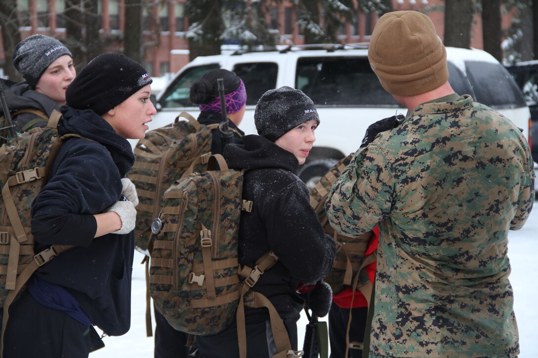 Female poolees hike through the trails around Historic Fort Snelling with the Marines of Marine Corps Recruit Station Twin Cities, Jan. 26. During the hike, the poolees carried rubber rifles and a heavily loaded pack to simulate the burdens they will be expected to carry in Marine recruit training.