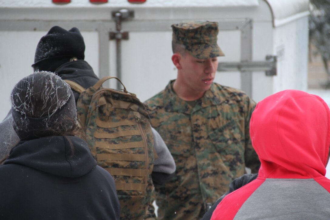 Female poolees hike through the trails around Historic Fort Snelling with the Marines of Marine Corps Recruit Station Twin Cities, Jan. 26. During the hike, the poolees carried rubber rifles and a heavily loaded pack to simulate the burdens they will be expected to carry in Marine recruit training.