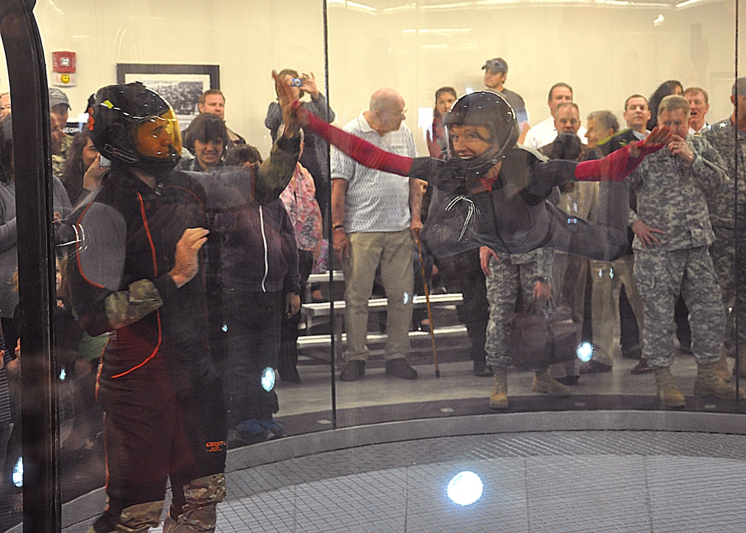 YUMA PROVING GROUND, Ariz. –Michelle Bannar gives an aerial high five to U.S. Navy Chief Parachute Rigger Justin Hodge, Military Freefall School instructor and assistant wind tunnel manager, as she inaugurates the Master Sgt. George A. Bannar Vertical Wind Tunnel facility following the dedication ceremony held Jan. 24 on Yuma Proving Ground. Members of the U.S. Army Corps of Engineers Los Angeles District, who helped construct the $10 million facility, attended the ceremony for the facility named for Bannar’s husband who was killed in action in Afghanistan in 2013. 