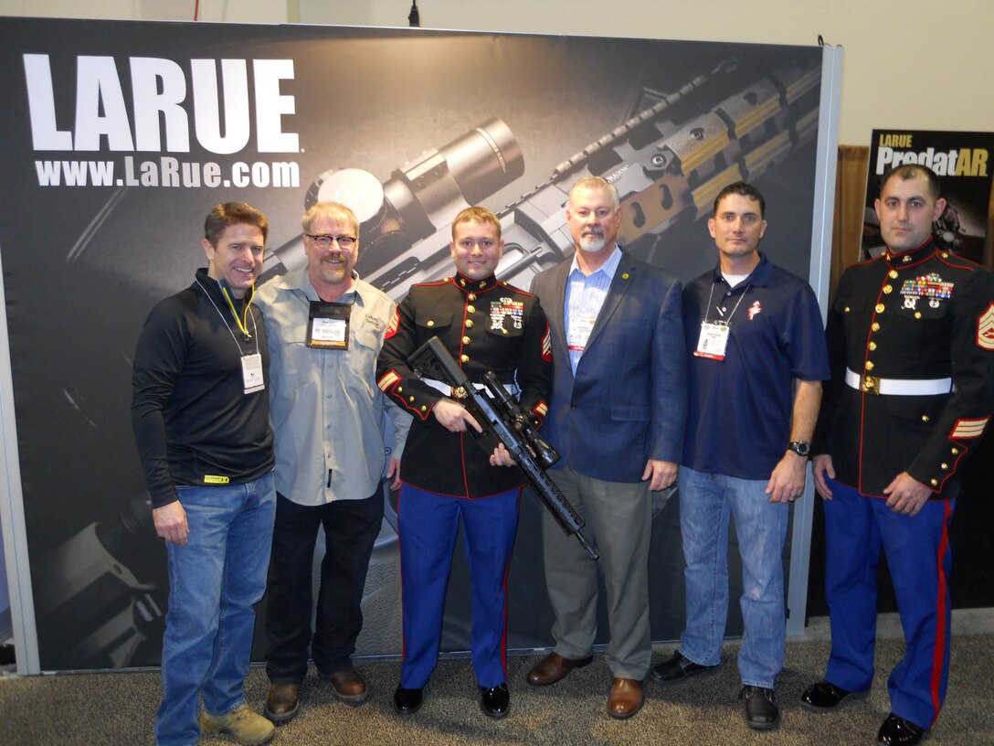 Sgt. David Mortensen and a few people involved with presenting Mortensen with the Marine Corps Scout Sniper Instructor of the Year Award, pose for a picture on Jan. 14, 2014, in Las Vegas. Mortensen was selected over three other Marine scout sniper instructors to win the award. 
