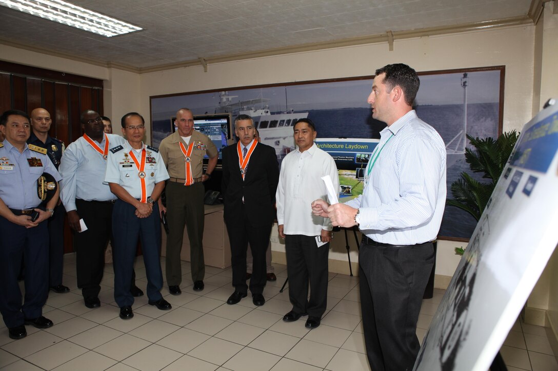 Chad Teegardin (right), contractor for Special Surveillance Programs at Naval Air Systems, explains the capabilities of the Maritime Persistent Surveillance Tower system to senior Philippine and U.S. officials during the initial maritime domain awareness demonstration at the Philippine Coast Guard Headquarters in Manila, Philippines, Jan. 27. The MPST is a land-based, mobile, multi-sensor payload platform that supports persistent 360-degree surveillance operations. The MPST detects and monitors surface contacts operating in the littorals, with various advanced sensors. The system is tailorable to meet specific requirements and mission parameters.