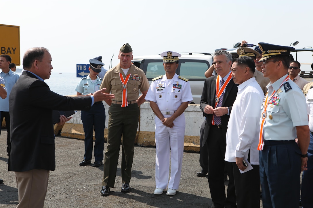 Rick DeGuzman (left), deputy assistant chief of staff for operations at U.S. Marine Corps Forces, Pacific, escorts senior Philippine and U.S. officials during the initial maritime domain awareness demonstration at the Philippine Coast Guard Headquarters in Manila, Philippines, Jan. 27. Initiatives like the maritime domain awareness experiment help to maintain a high level of interoperability, enhance our military-to-military relations, and improve our combined capabilities.