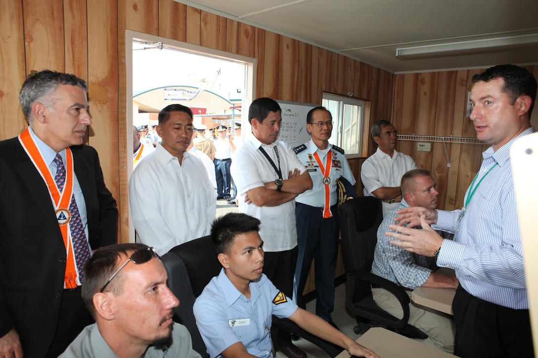 Chad Teegardin (right), contractor for Special Surveillance Programs at Naval Air Systems, explains the capabilities of the Maritime Persistent Surveillance Tower system to senior Philippine and U.S. officials during the initial maritime domain awareness demonstration at the Philippine Coast Guard Headquarters in Manila, Philippines, Jan. 27. The MPST is a land-based, mobile, multi-sensor payload platform that supports persistent 360-degree surveillance operations. The MPST detects and monitors surface contacts operating in the littorals, with various advanced sensors. The system is tailorable to meet specific requirements and mission parameters.