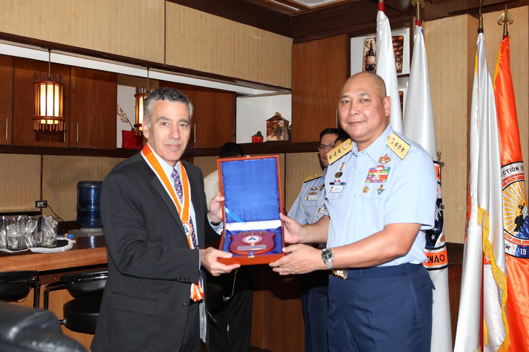 Vice Adm. Rodolfo D. Isorena (right), the Philippine Coast Guard commandant, presents a plaque to the U.S. Ambassador to the Philippines, the honorable Philip Goldberg, during the initial maritime domain awareness demonstration at the Philippine Coast Guard Headquarters in Manila, Philippines, Jan. 27.