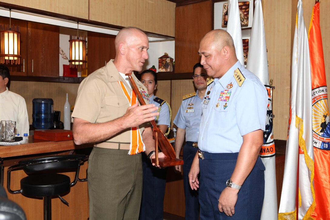 U.S. Marine Brig. Gen. Richard L. Simcock II (left), the deputy commanding general of U.S. Marine Corps Forces, Pacific, presents a Hawaiian paddle plaque to Vice Adm. Rodolfo D. Isorena, the Philippine Coast Guard commandant, during the initial maritime domain awareness demonstration at the Philippine Coast Guard Headquarters in Manila, Philippines, Jan. 27.