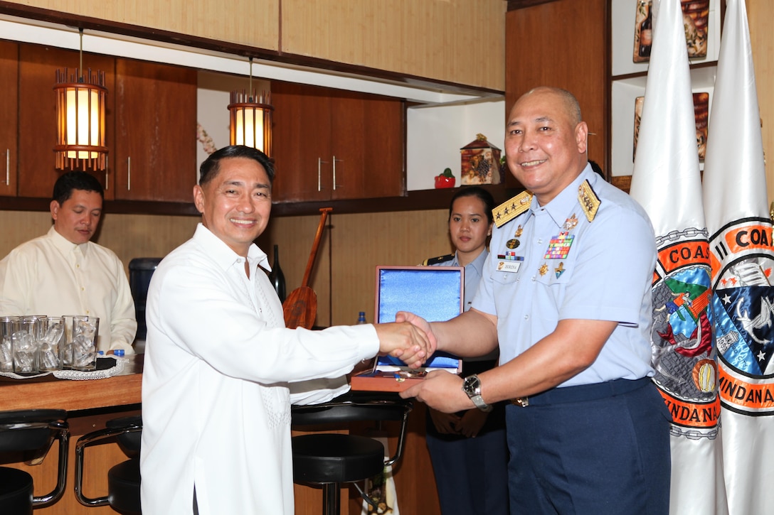 Vice Adm. Rodolfo D. Isorena (right), the Philippine Coast Guard commandant, presents a plaque to Sec. Cesar P. Garcia Jr., national security advisor to the president of the Philippines, during the initial maritime domain awareness demonstration at the Philippine Coast Guard Headquarters in Manila, Philippines, Jan. 27.