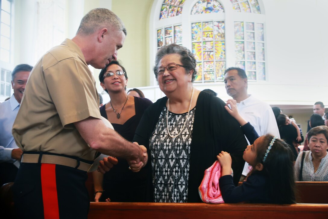 Marine Brig. Gen. Paul Kennedy, deputy commanding general of III Marine Expeditionary Force and commanding general of 3rd Marine Expeditionary Brigade in Okinawa, Japan, offers condolences to Patricia Blaz Borja, the sister of retired Marine Brig. Gen. Vincente “Ben” T. Blaz, during a service Jan. 18 to honor Blaz, who died Jan. 8 at the age of 85. (Official U.S. Marine Corps photo by Sgt. John Raufmann)