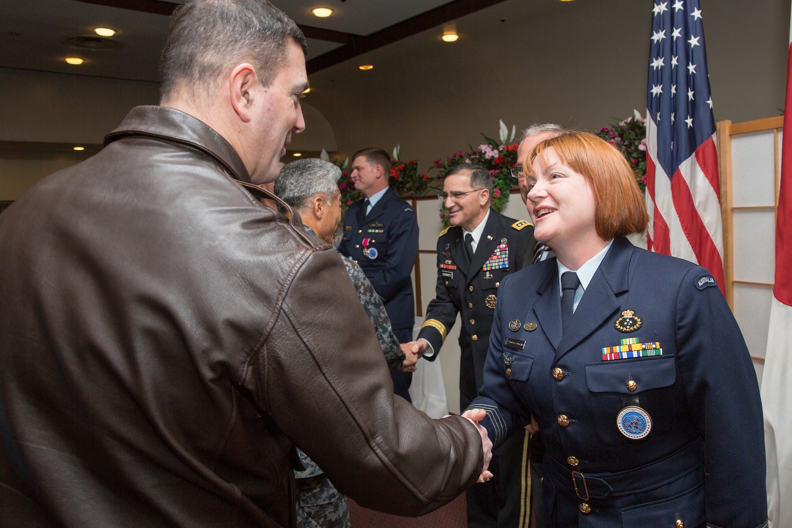 (Left to right) U.S. Air Force Col. Mark August, 374th Airlift Wing commander, congratulates Royal Australia Air Force Group Captain Barbara Courtney, United Nations Command (Rear) commander, after the UNC (Rear) change of command ceremony at Yokota Air Base, Japan, Jan. 28, 2014. As the United Nations Command’s principal representative in Japan, the UNC (Rear) maintains the status of forces agreement regarding United Nations Forces in Japan during armistice conditions. (U.S. Air Force photo by Osakabe Yasuo/Released)