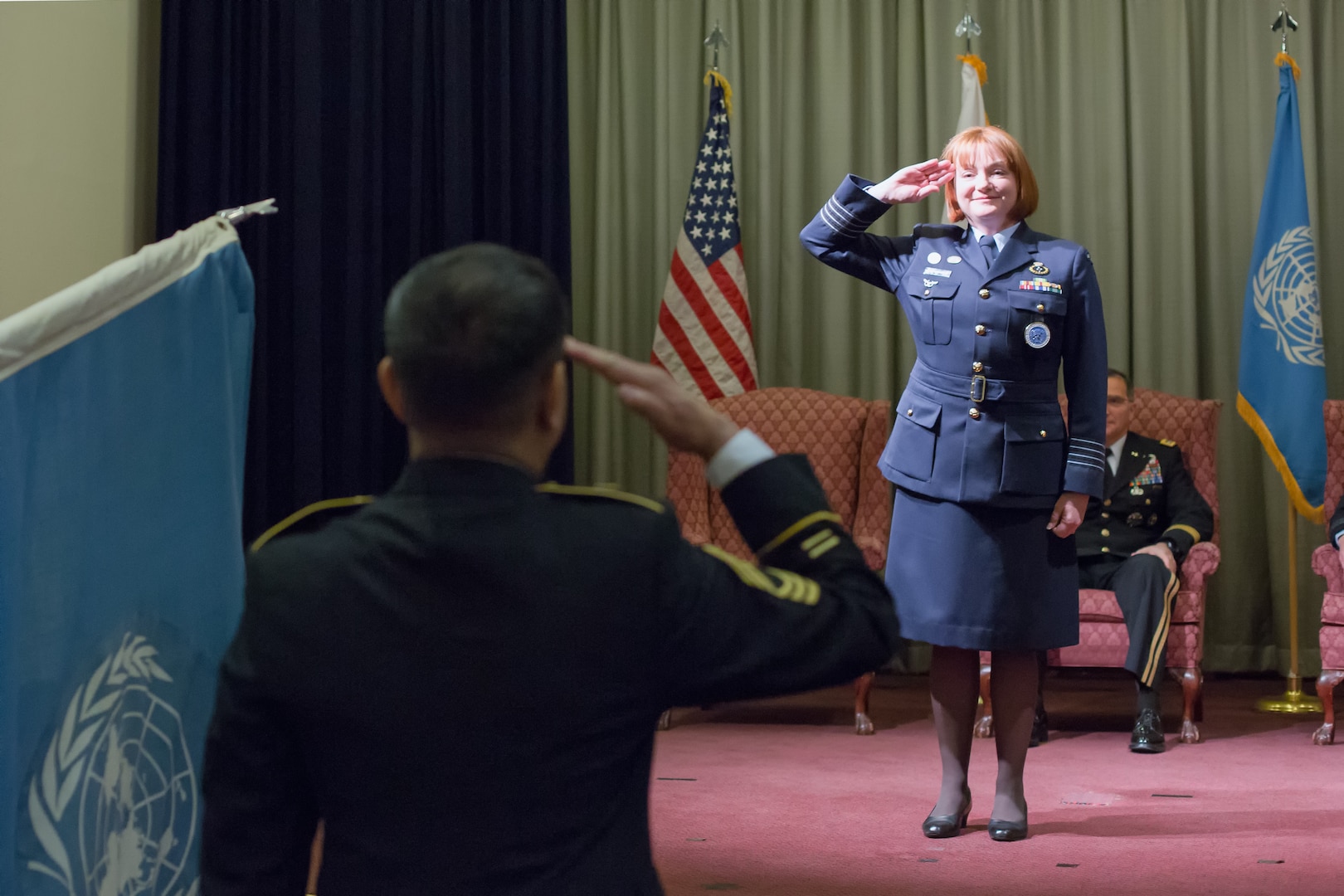 Royal Australia Air Force Group Captain Barbara Courtney, United Nations Command (Rear) commander, renders her first salute as commander during the UNC (Rear) change of command ceremony at Yokota Air Base, Japan, Jan. 28, 2014. Courtney assumed command from Royal Australia Air Force Group Captain Luke Stoodley. (U.S. Air Force photo by Osakabe Yasuo/Released)