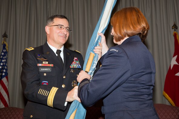 (Right to left) Royal Australia Air Force Group Captain Barbara Courtney, incoming United Nations Command (Rear) commander, receives the guidon from U.S. Army Gen. Curtis Scaparrotti, commander of the United Nations Command, Combined Forces Command, and U.S. Forces Korea, during a change of command ceremony at Yokota Air Base, Japan, Jan. 28, 2014. As the UNC’s principal representative in Japan, the UNC (Rear) maintains the status of forces agreement regarding United Nations Forces in Japan during armistice conditions. (U.S. Air Force photo by Osakabe Yasuo/Relased) 